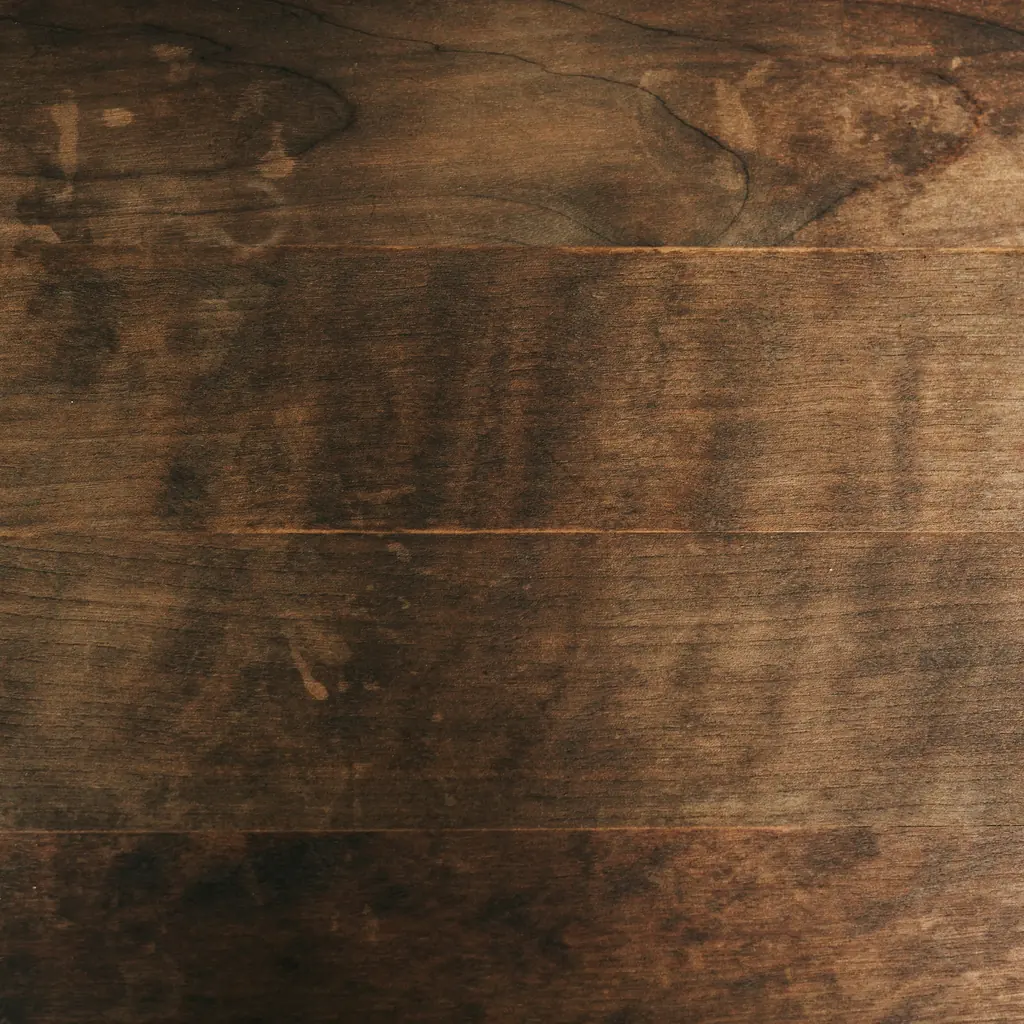 Close-up of a dark walnut surface with a fine straight grain.