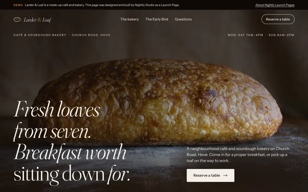 The Larder & Loaf demo on a laptop screen: the headline “Fresh loaves from seven. Breakfast worth sitting down for.” in a light italic serif over a photo of a sourdough loaf on a dark bench.
